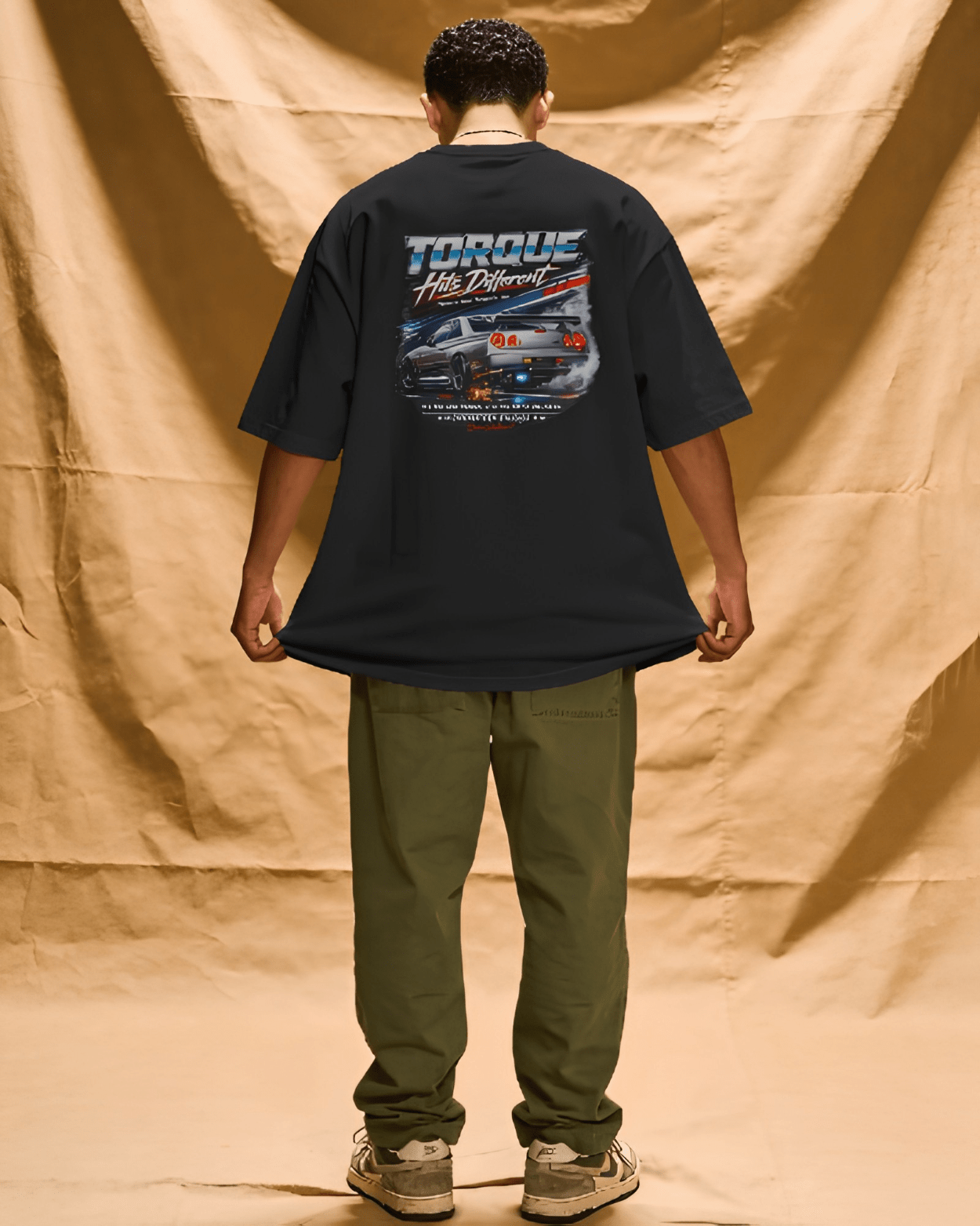 Torque Hits Different oversized motorsport tee worn by model, back print, India